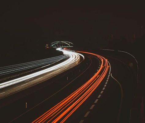 Long-exposure light trails from traffic on a motorway at night