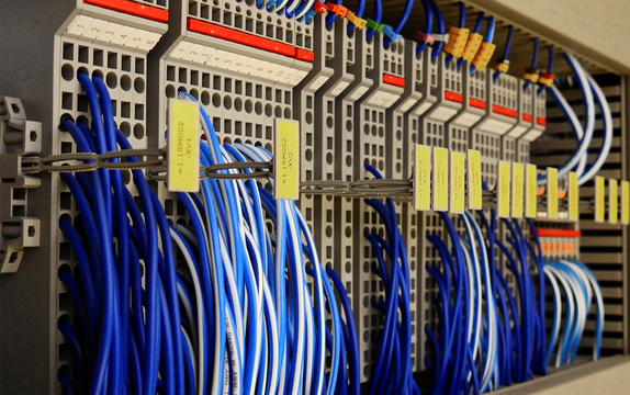 Neatly routed and labelled blue network patch cables inside a rack